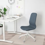 Home office setup: white desk, blue LÅNGFJÄLL chair, white lamp, plant, clock.