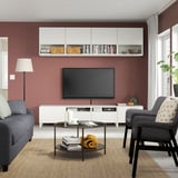 Cozy living room with red walls, gray furniture, tv, and decor.