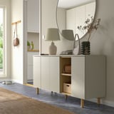 Minimalist white cabinet, LEDAMOT, with wood shelves. Mirror, lamp, decor. Bright entryway with natural elements.