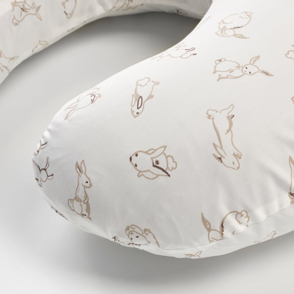 Cuddly white baby pillow with soft, enjoyably printed bunnies, crafted from smooth cotton.