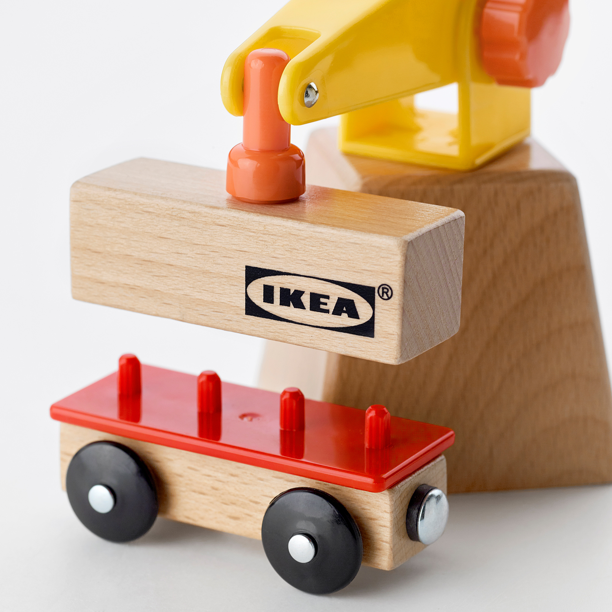 Wooden toy crane by ikea, holding a labeled block, showcasing quality craftsmanship.