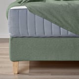 Green divan bed with cushions, oak legs, green fabric, highlighted comfort.