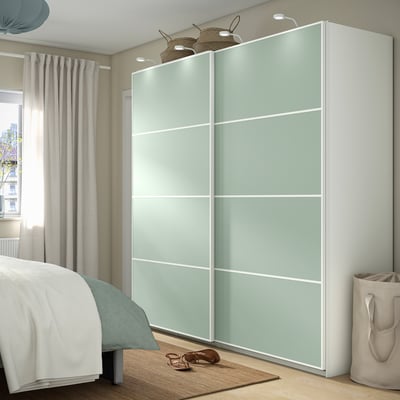 MEHAMN pastel sliding doors in bedroom. Light blue-green panels with white sides, matching bedding, large. Courtside furniture, clean aesthetic.