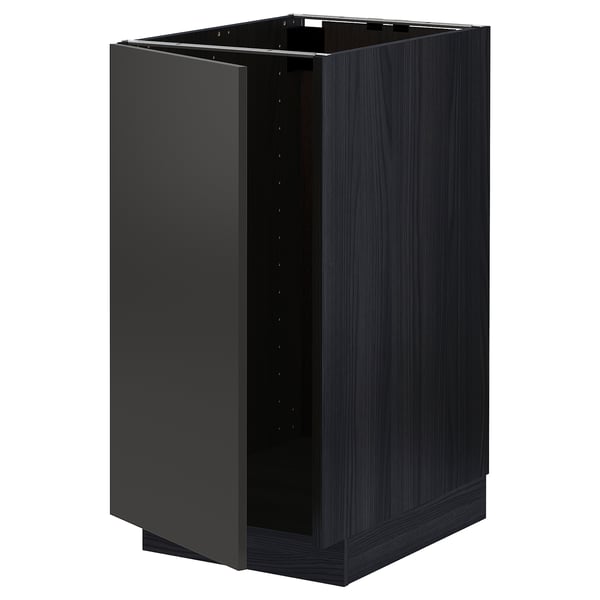 A dark grey ikea METOD kitchen cabinet with a wood grain finish and one open door revealing its interior.