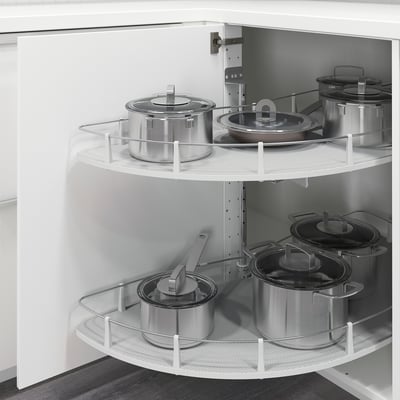 Kitchen corner cabinet with pull-out carousels holding pots and pans for easy access, part of the METOD system.