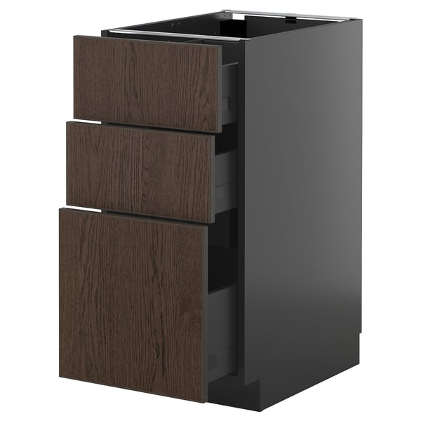 Modern kitchen unit, black with dark wood drawers, sleek design.