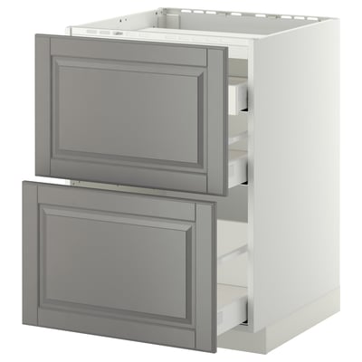 A white METOD kitchen cabinet with grey bodbyn drawers, featuring a traditional design with beveled edges.