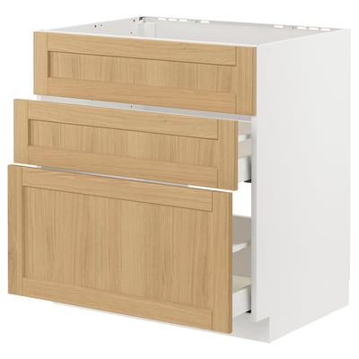 Depicts a white METOD kitchen cabinet with light wood veneer drawers, featuring three open drawers.