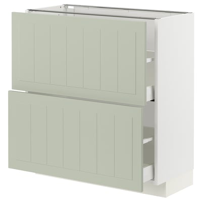 A light green METOD kitchen cabinet with smooth drawers and a crafted design.