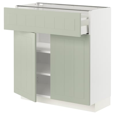 Modern kitchen cabinet, pale green, rectangular, with a drawer and two doors. Made from fiberboard and particleboard.