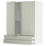A green METOD kitchen cabinet with drawers and adjustable shelves.