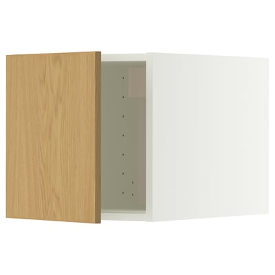 A white kitchen cabinet with a wooden door. The door has hinges and is open, revealing the interior.