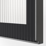 Close-up of modern metallic kitchen cabinet with sleek black handle. Vertical grooves enhance texture and design.