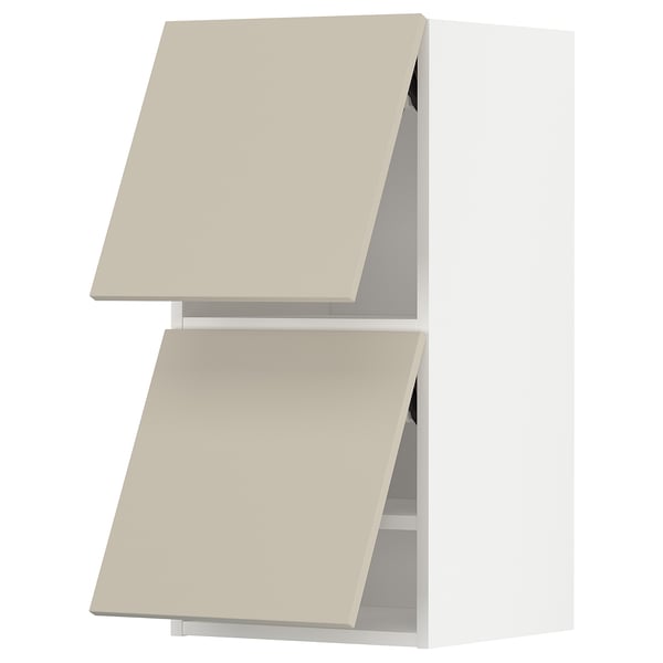 Two beige METOD kitchen wall cabinets with angled doors in a minimalist design.