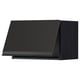Black modern kitchen unit with minimalist design and sleek handle.