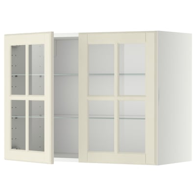 Off-white kitchen cabinet with glass doors and shelves.