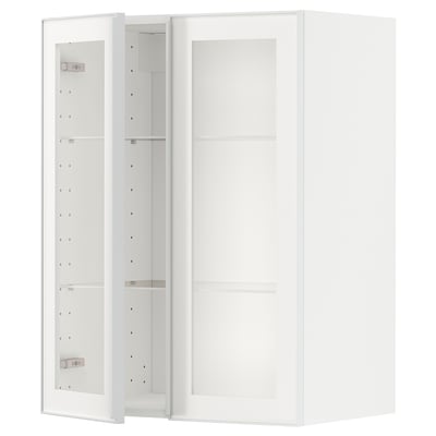 A white METOD kitchen cabinet with a glass door and metal frame, featuring adjustable shelves.