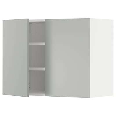 A gray METOD wall kitchen cabinet with two doors open, revealing shelves inside.