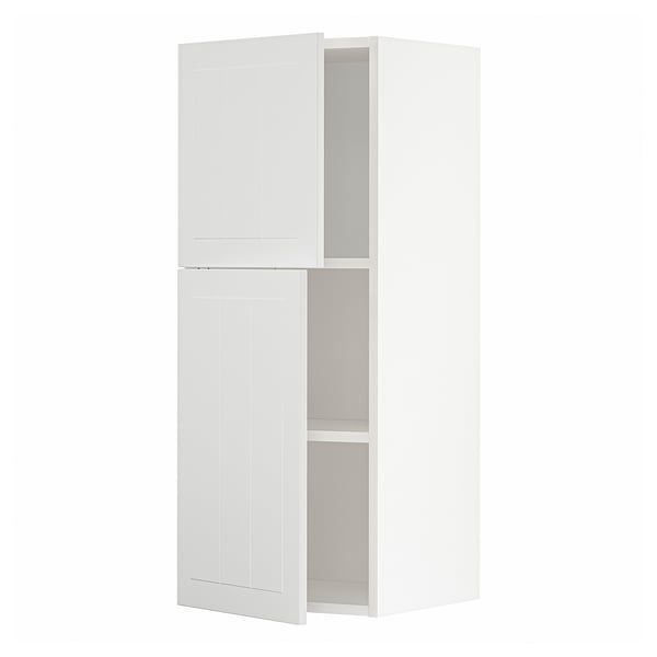 A white METOD kitchen cabinet with two doors. It is rectangular and modern, designed for storage.