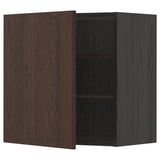 A METOD dark brown kitchen cabinet with a wooden door partially open, revealing two shelves inside.