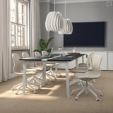 Modern MITTZON conference table with 8 swivel chairs, well-lit room, pendant light, tv, clean lines.