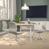 Modern conference room with MITTZON round table, light wood top, white legs, grey chairs, and large screen.