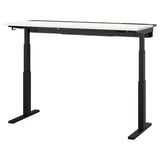 The MITTZON desk is black with a light-colored top, featuring a sleek, rectangular shape and adjustable legs.