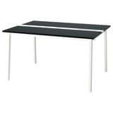 The MITTZON table has a dark grey top and white legs, made of sturdy materials for easy cleaning.