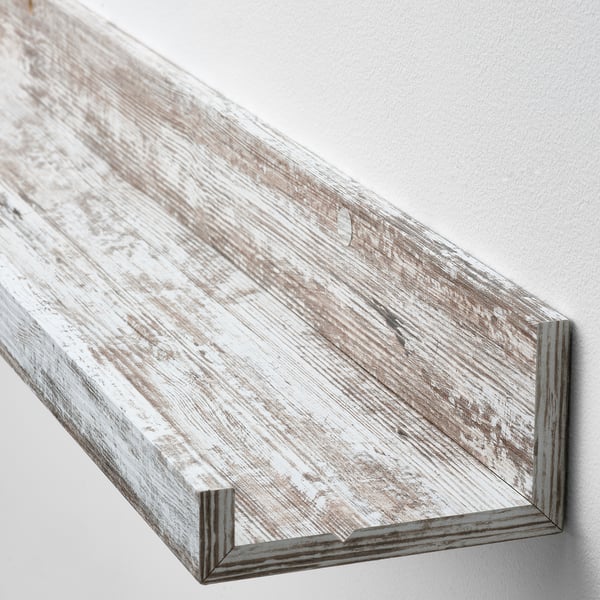 Whitewashed wooden shelf mounted on wall, displaying rustic, high-quality craftsmanship.
