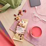 IKEA MUNSBIT mix spills on wood with cloth, cup, earphones, phone.