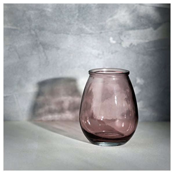 Single small, bubbly, purple-hued glass vase stands alone, showcasing its unique recycled texture and soft color.