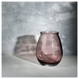 Single small, bubbly, purple-hued glass vase stands alone, showcasing its unique recycled texture and soft color.