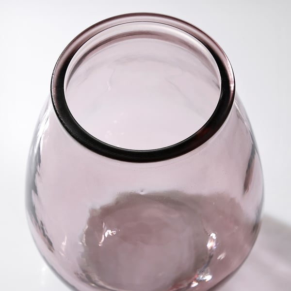 A recycled glass vase with visible air bubbles and a slightly varied color, reflecting its unique design and eco-friendly composition.