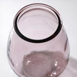 A recycled glass vase with visible air bubbles and a slightly varied color, reflecting its unique design and eco-friendly composition.