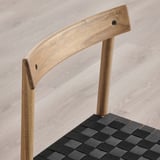 Well-crafted wooden chair with woven seat, curved back, and sturdy design.