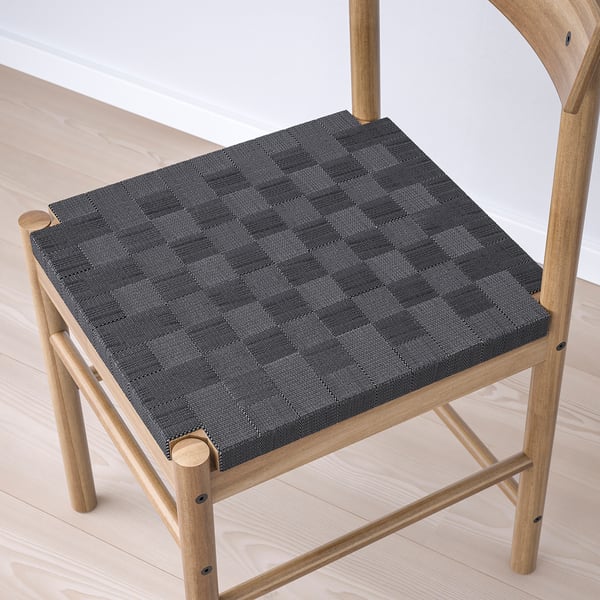 Modern wooden chair with woven seat for comfort. Solid acacia construction, stylish design.