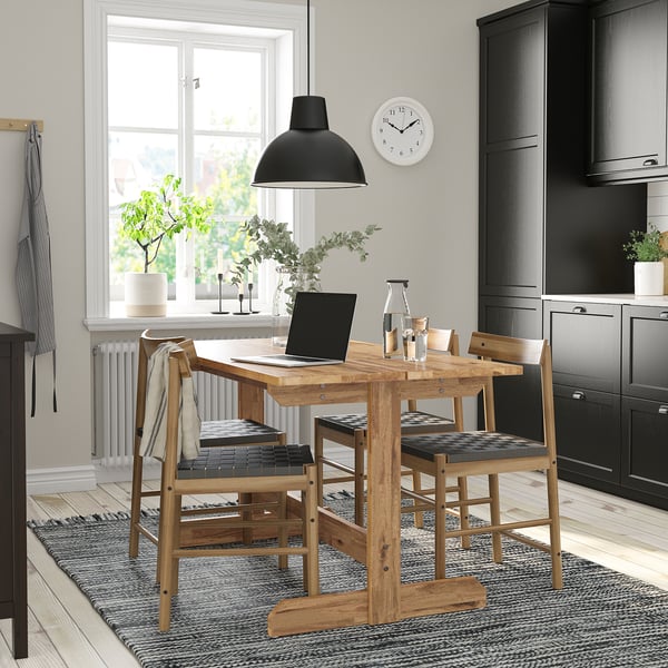 Cozy dining setup with NACKANÄS table, 4 chairs, pendant lamp, and window. Dark cabinetry, light wood flooring.