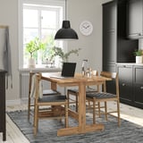 Cozy dining setup with NACKANÄS table, 4 chairs, pendant lamp, and window. Dark cabinetry, light wood flooring.