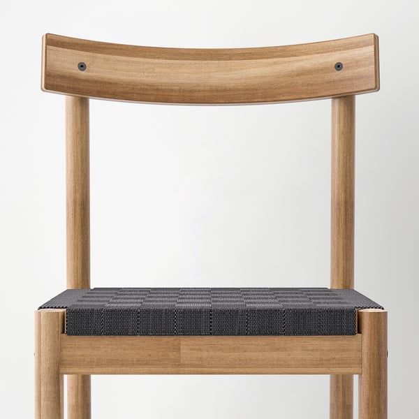 Chair with curved wooden back and woven seat, showcasing natural wood grain and durable design.