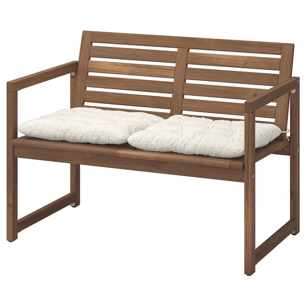 Brown acacia wood bench with white cushions.