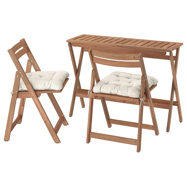 A NÄMMARÖ outdoor furniture set. It includes a brown acacia wood foldable table and two matching chairs with beige cushions.