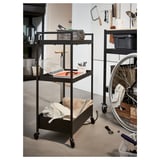 Black rolling storage cart with three shelves, featuring tools, towels, and boxes; ideal for garage or workshop organization.