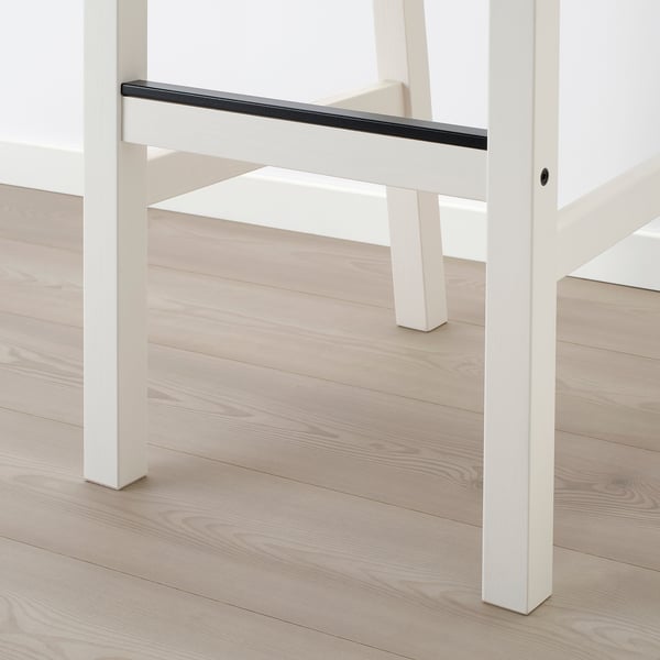 White metal bar table with sleek, glossy surface. Sturdy, rectangular legs. Modern, minimalist design. Floor reflector enhances clean look.