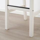 White metal bar table with sleek, glossy surface. Sturdy, rectangular legs. Modern, minimalist design. Floor reflector enhances clean look.
