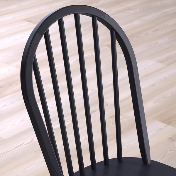 Sleek black chair with curved back and slatted design on wooden floor.