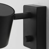 Black adjustable wall lamp with a rounded shade and metallic finish. Modern design, robust and stylish.