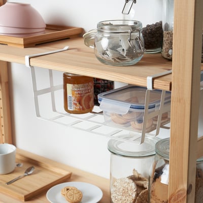 White PÅLYCKE steel basket for kitchen storage, clips onto shelves with grid pattern.