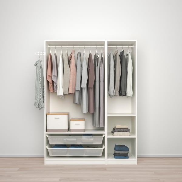 White closet with clothes, storage boxes, and wire basket. Clothes hangers visible at top.