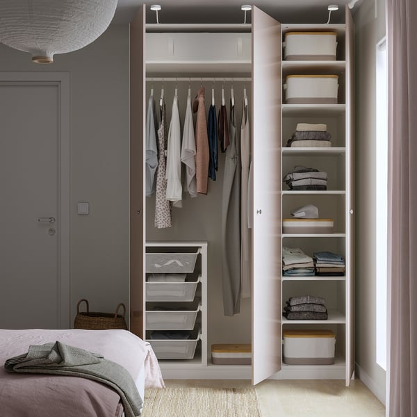 Built-in wardrobe with hanging garments, folded clothes, and mesh storage bins, featuring adjustable shelves.
