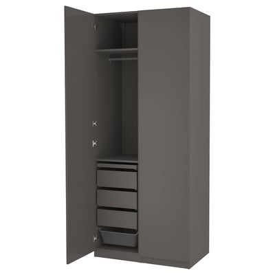 This image shows a modern, dark gray PAX wardrobe with drawers and shelves for storage.